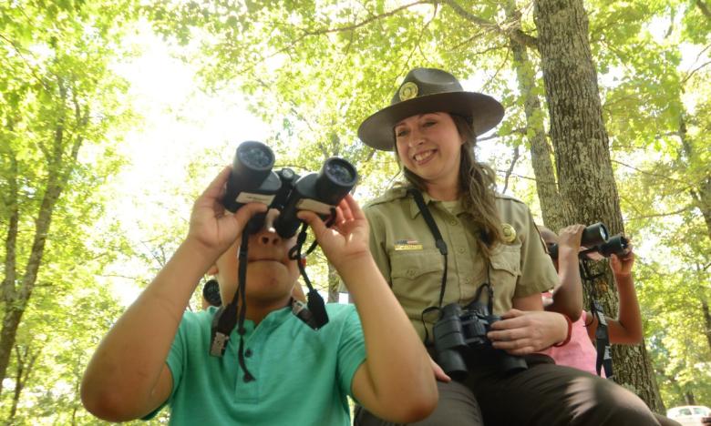 A Park Ranger giving a tour to a group of young explorers